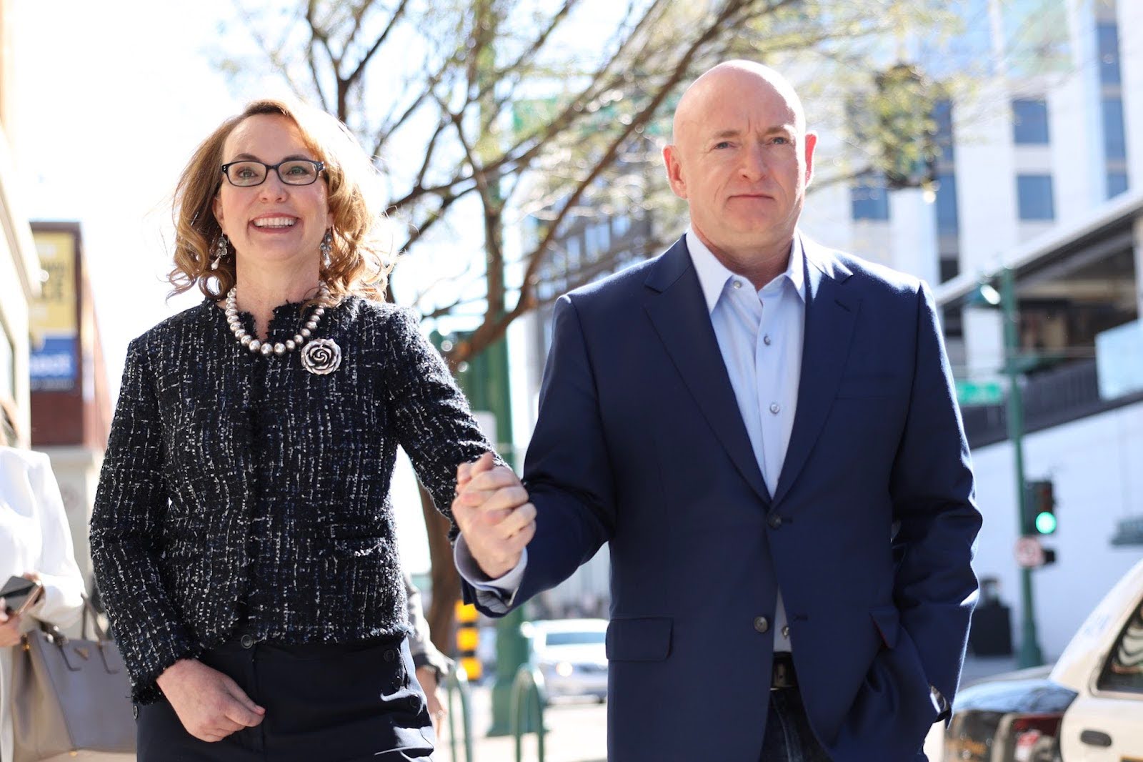 Gabby Giffords hand-in-hand with Mark Kelly